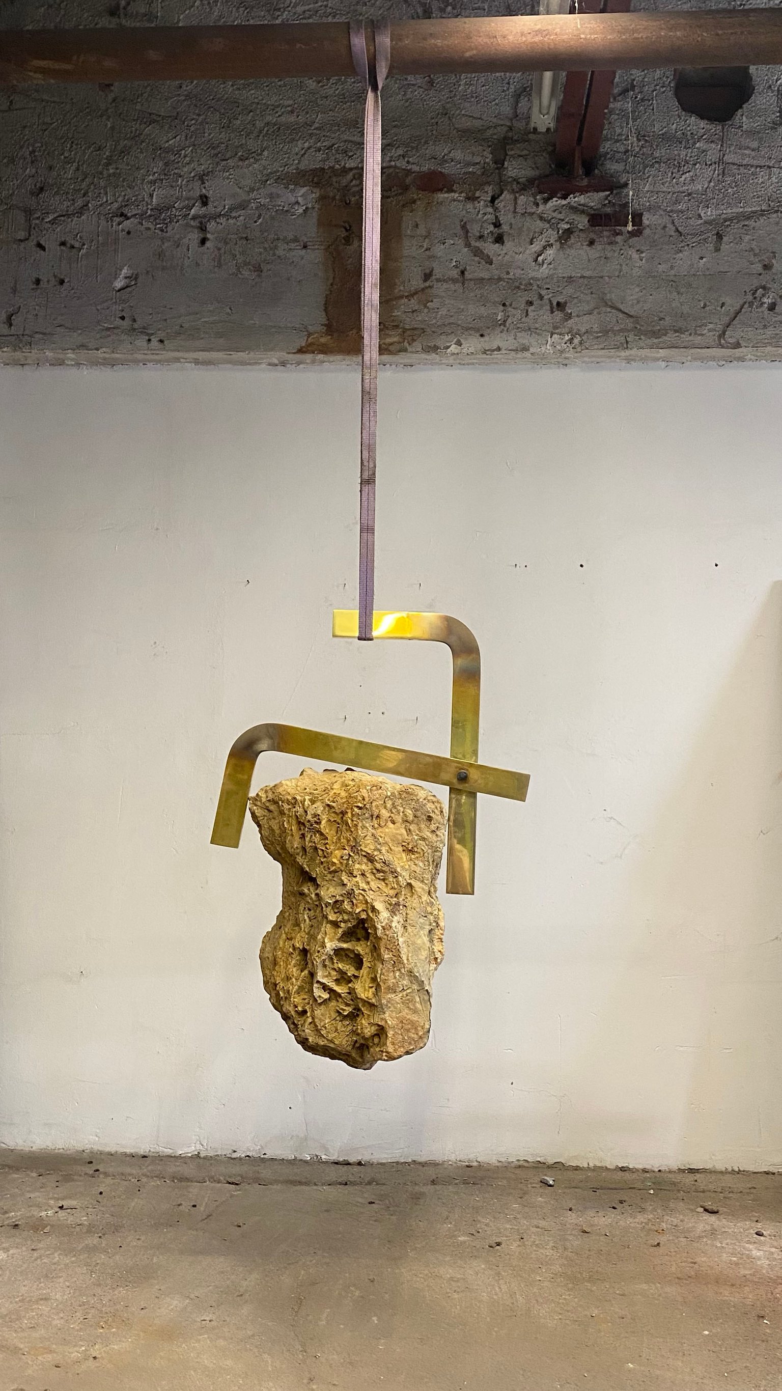Abschied von der Erde VI by Nino Maaskola, 2021, brass, stone, sling
