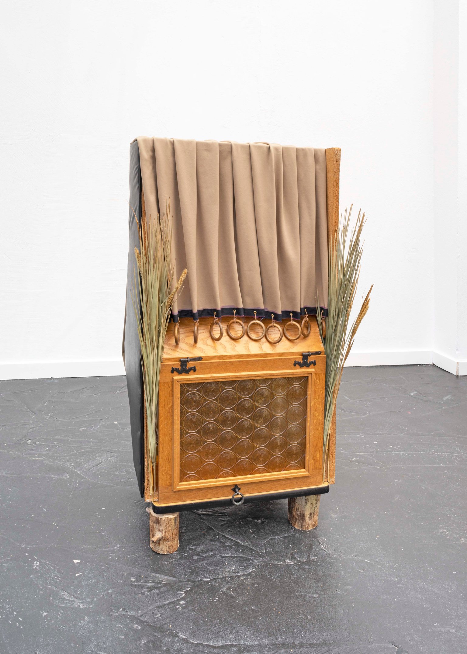 Roots, rock, bells by Miriam Schmitz, 2021, wood, glass, fabric, foam, leather, reed